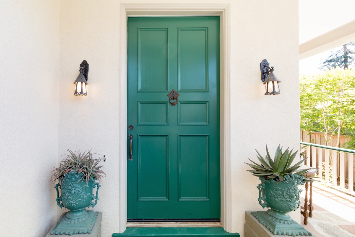 green front door with a door knock