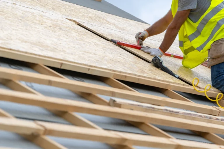 close up to worker installing roof deck