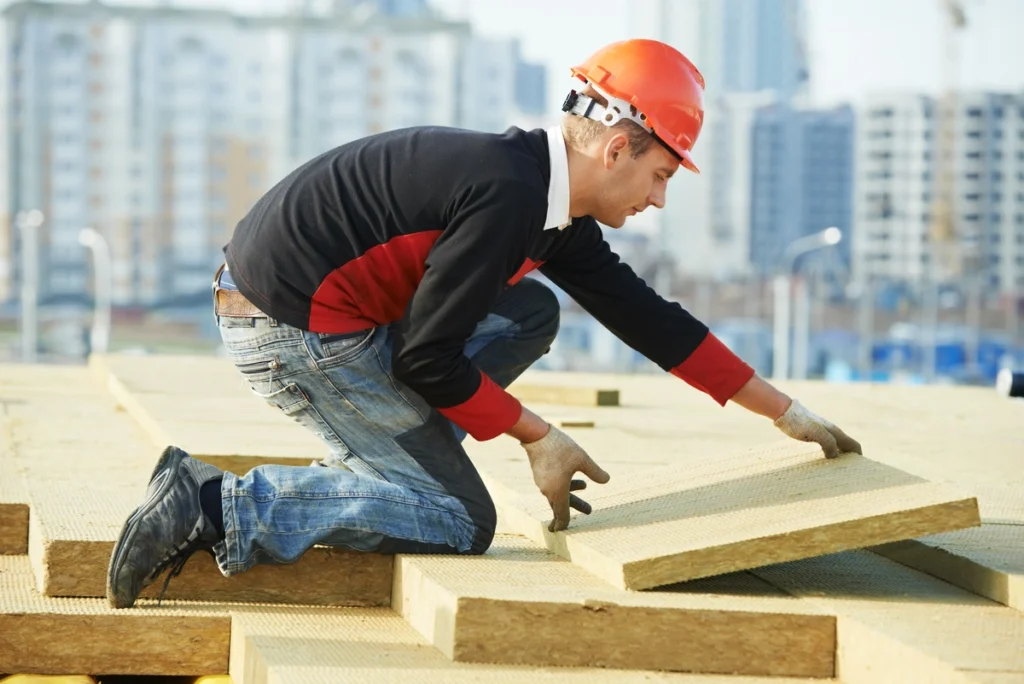 roof technician installing roof insulation