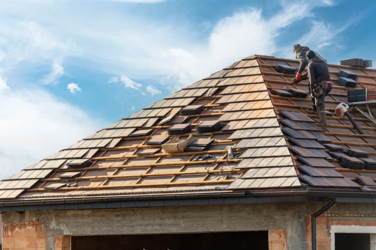 how to get insurance to pay for roof replacement-workers on a roof replacing roofing materials
