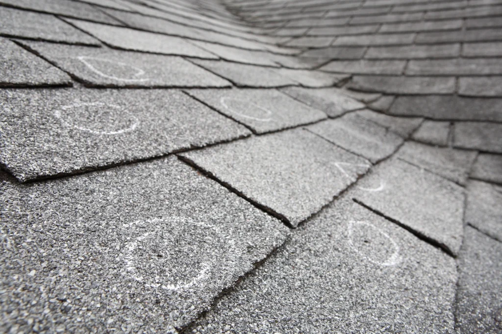 close up of roof shingles after hail storm damage
