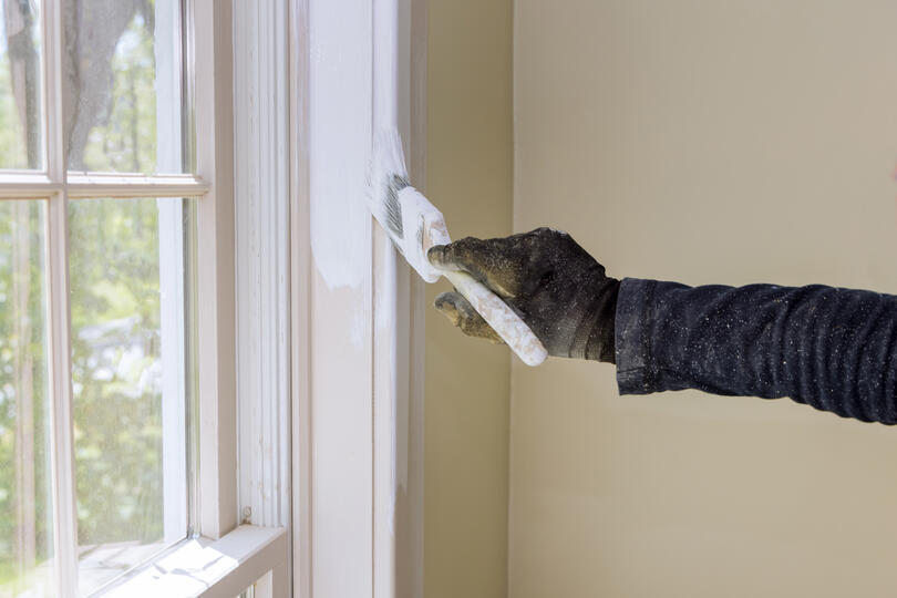 window painting ideas-gloved hand painting interior window trim a crisp white