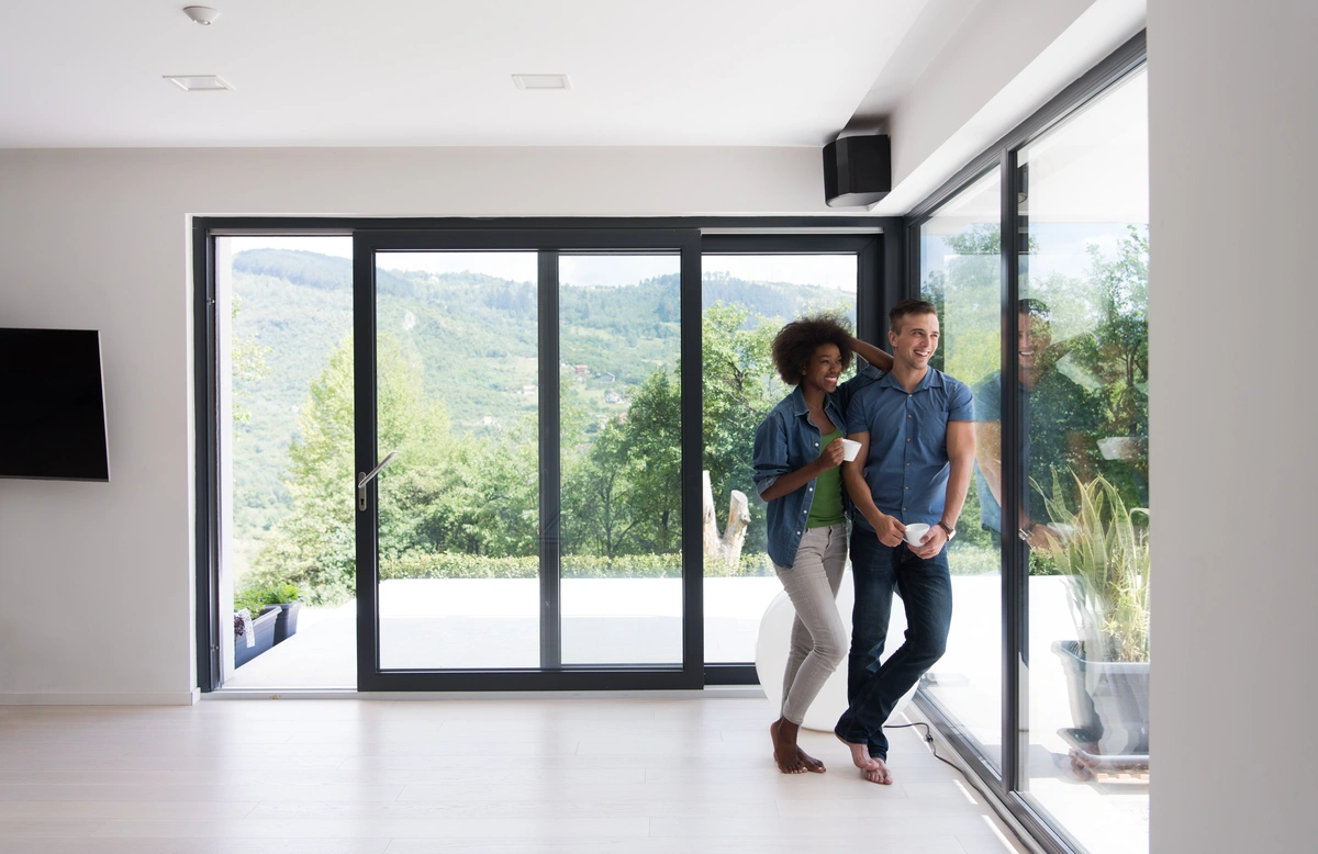 young couple standing by the window