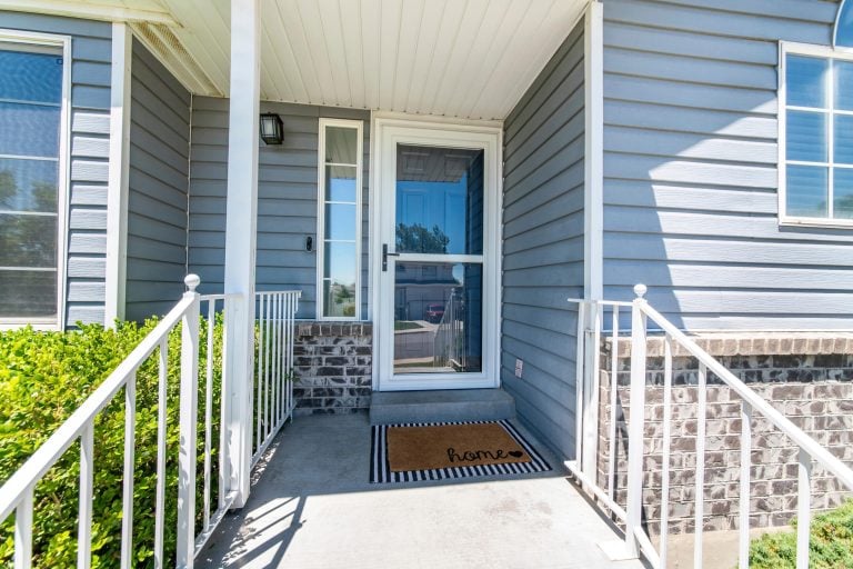how to install a storm door-blue sided house with a storm door and dark front door