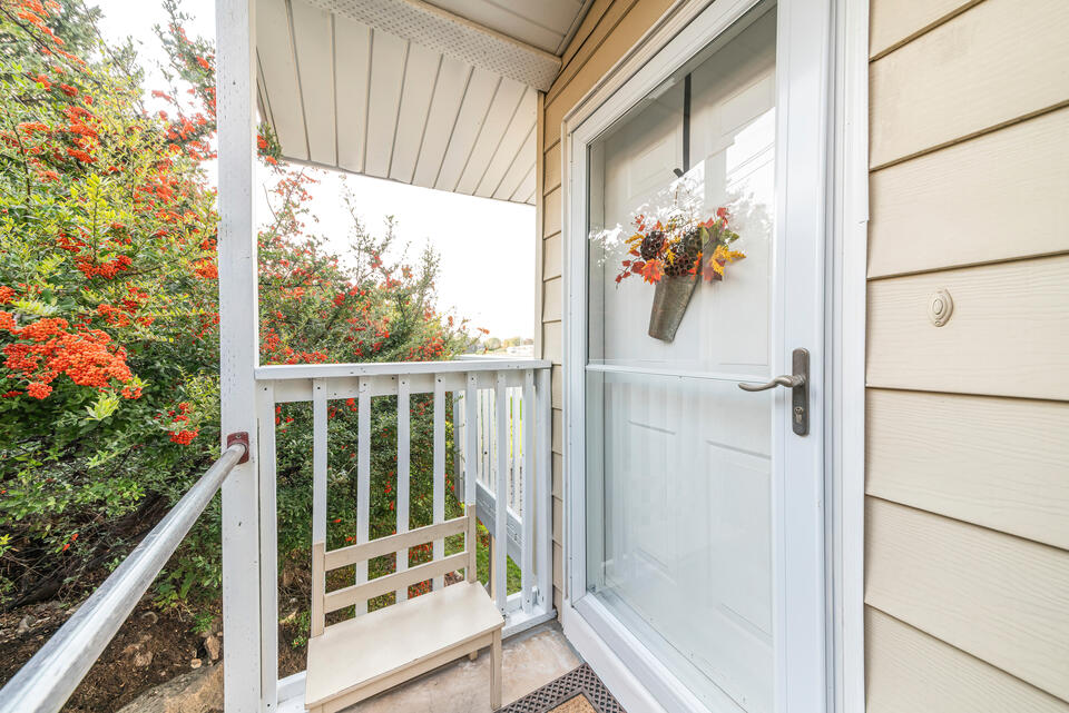 how to install a storm door-cream sided house with a storm door and white front door