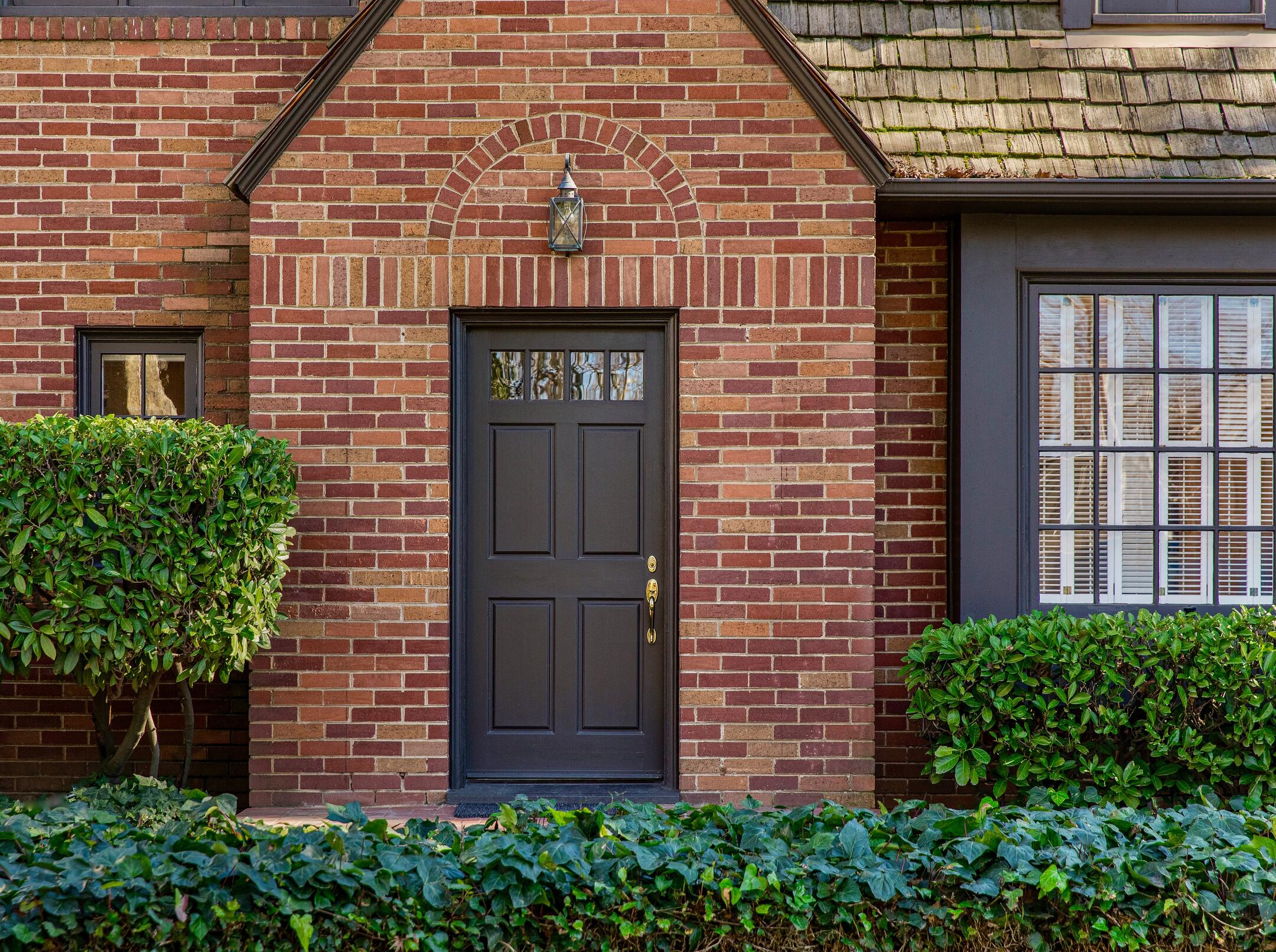 how to pick a front door color-brick house with a black front door