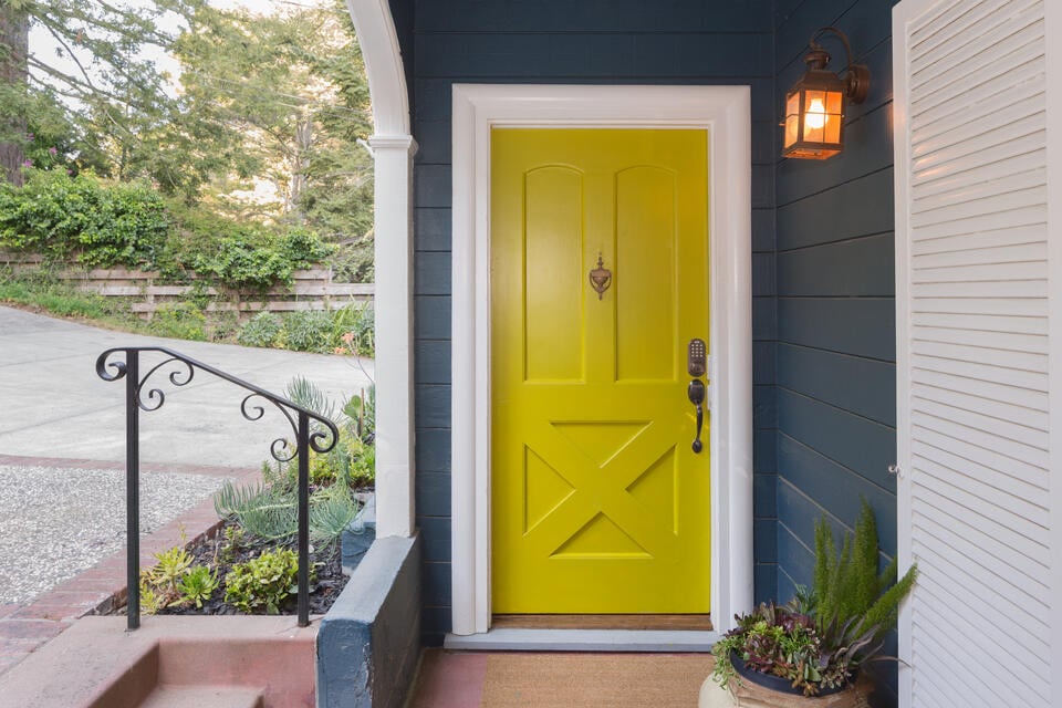 how to pick a front door color-dark navy sided house with a bright yellow front door