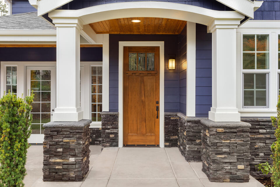 how to pick a front door color-navy blue house with a walnut stained wood front door