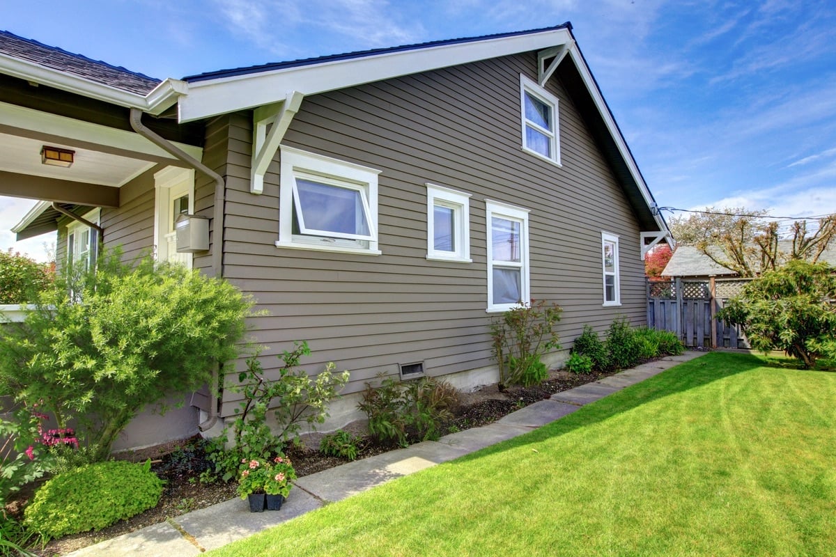 a house with a lawn and a fence