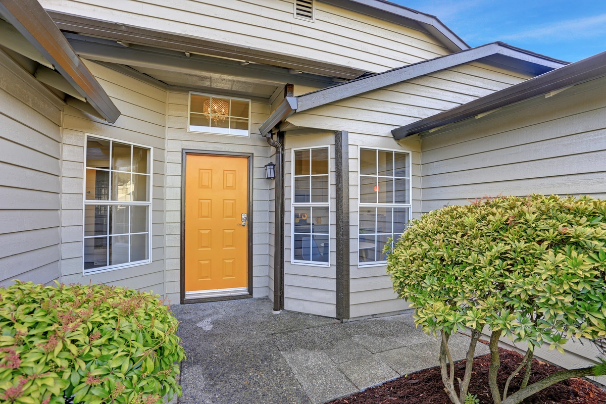 a yellow door in front of a house