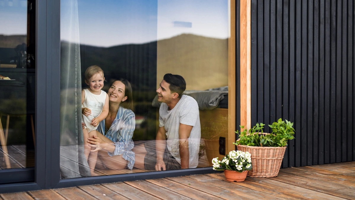 young parents and child by the window
