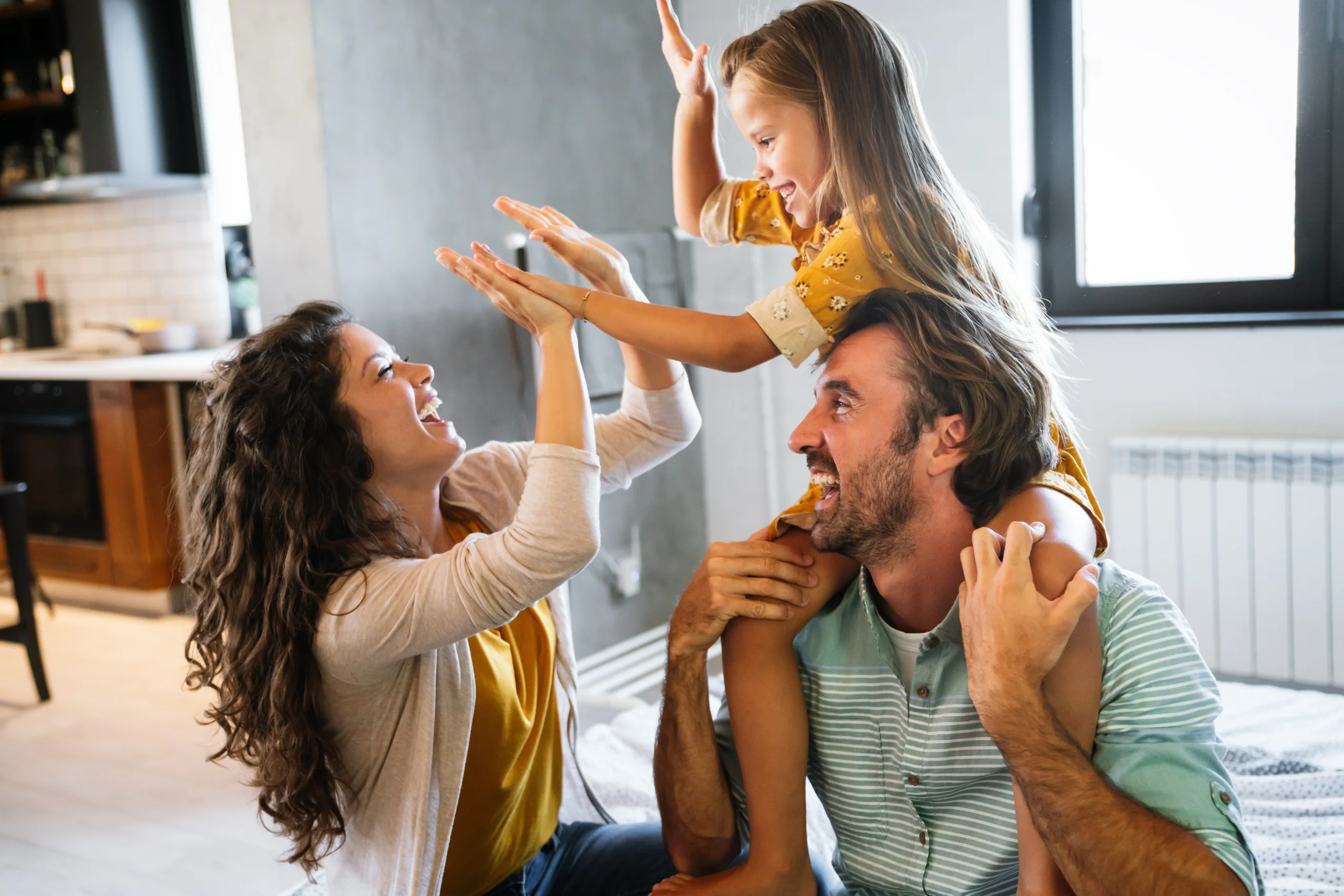 family of three laughing together