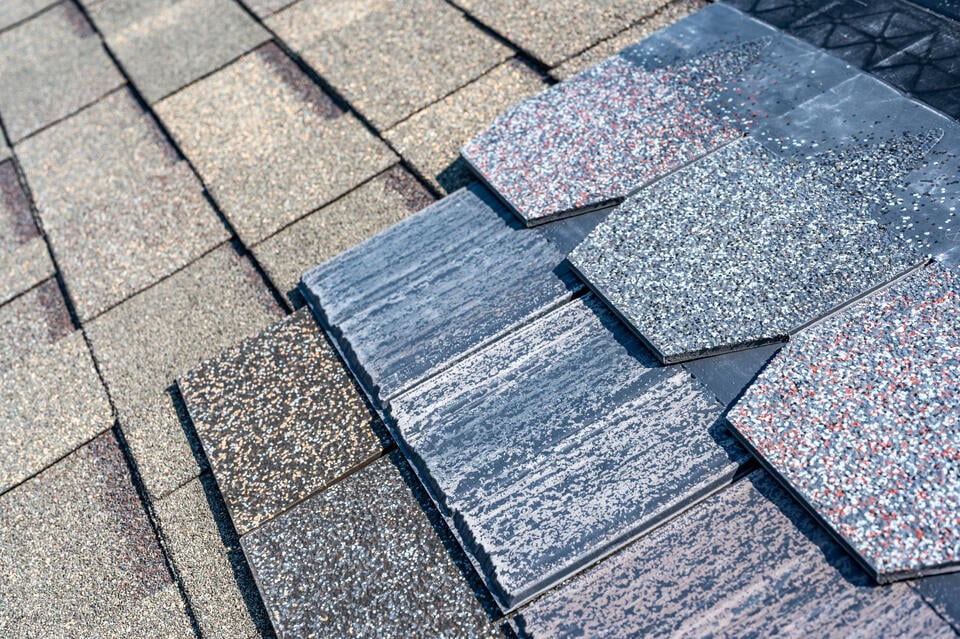luxury asphalt shingles-different style of shingles laid out for a homeowner to choose from