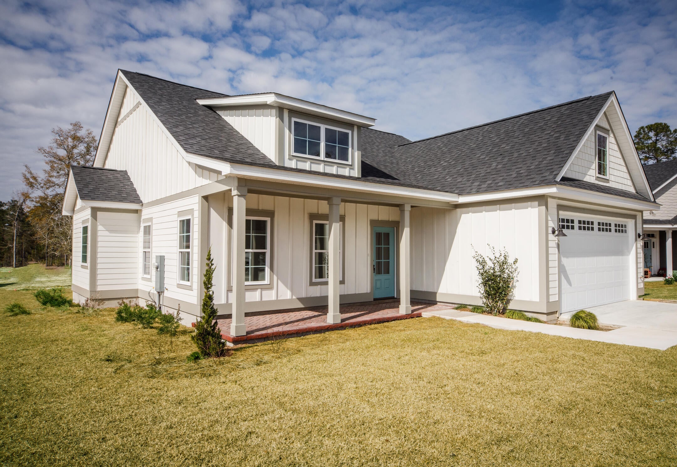 roof trim-white home with dark gray shingled roof