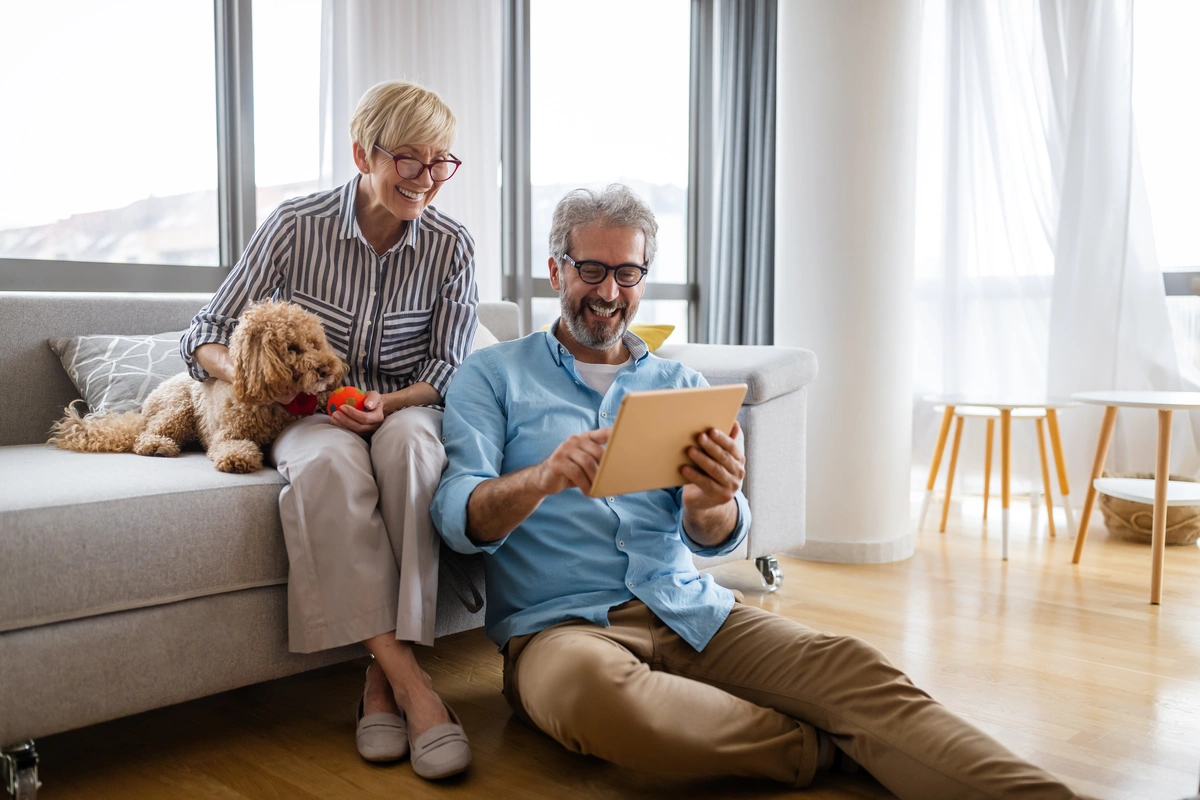 couple with their dog at home