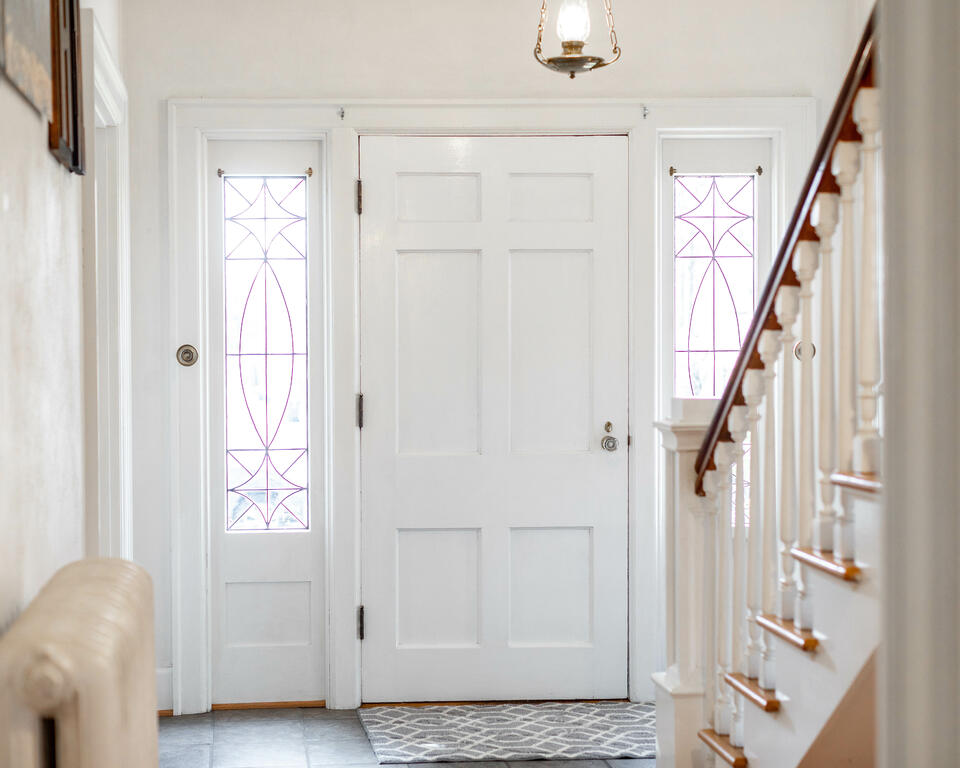 energy efficient doors-white front door inside a house entry way