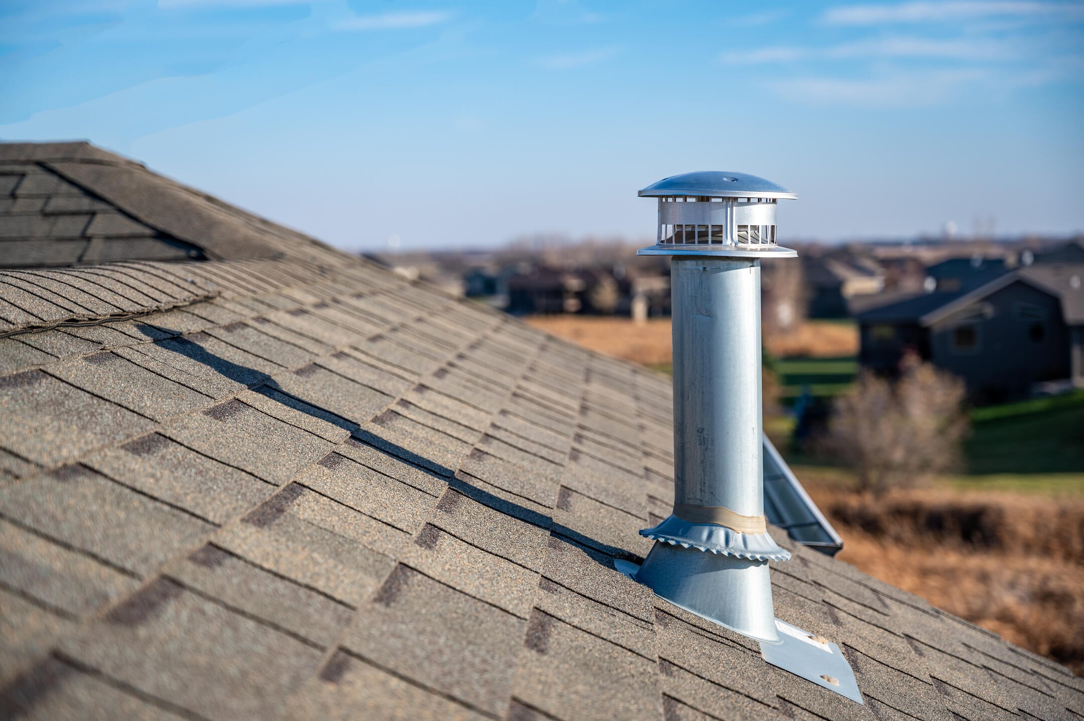 vent pipe flashing-side view of metal vent pipe and flashing on shingle roof