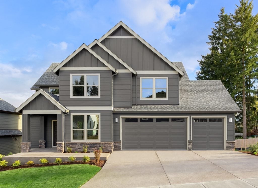 certainteed siding colors Front exterior of new home on sunny day. Features covered porch, three car garage, and gables