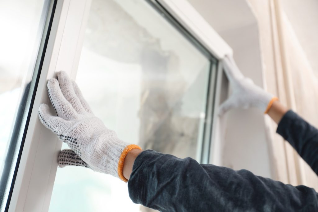 energy star most efficient windows Worker installing plastic window indoors, closeup view