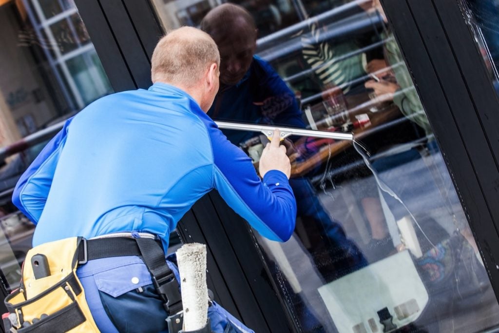 professional window cleaning window washer working  wash glass on building