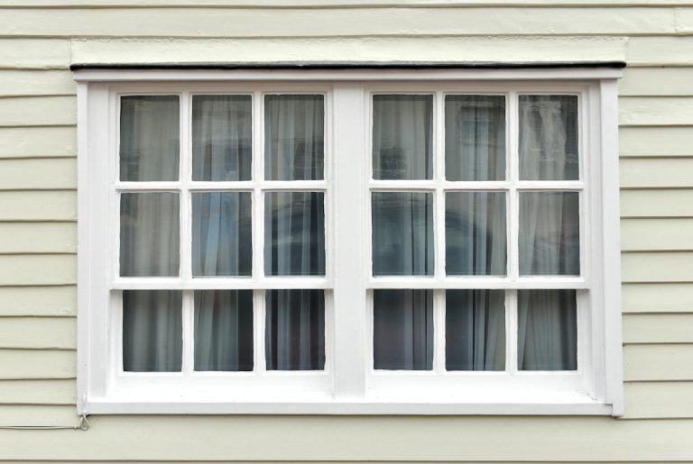 Old sash window and weatherboarding on house