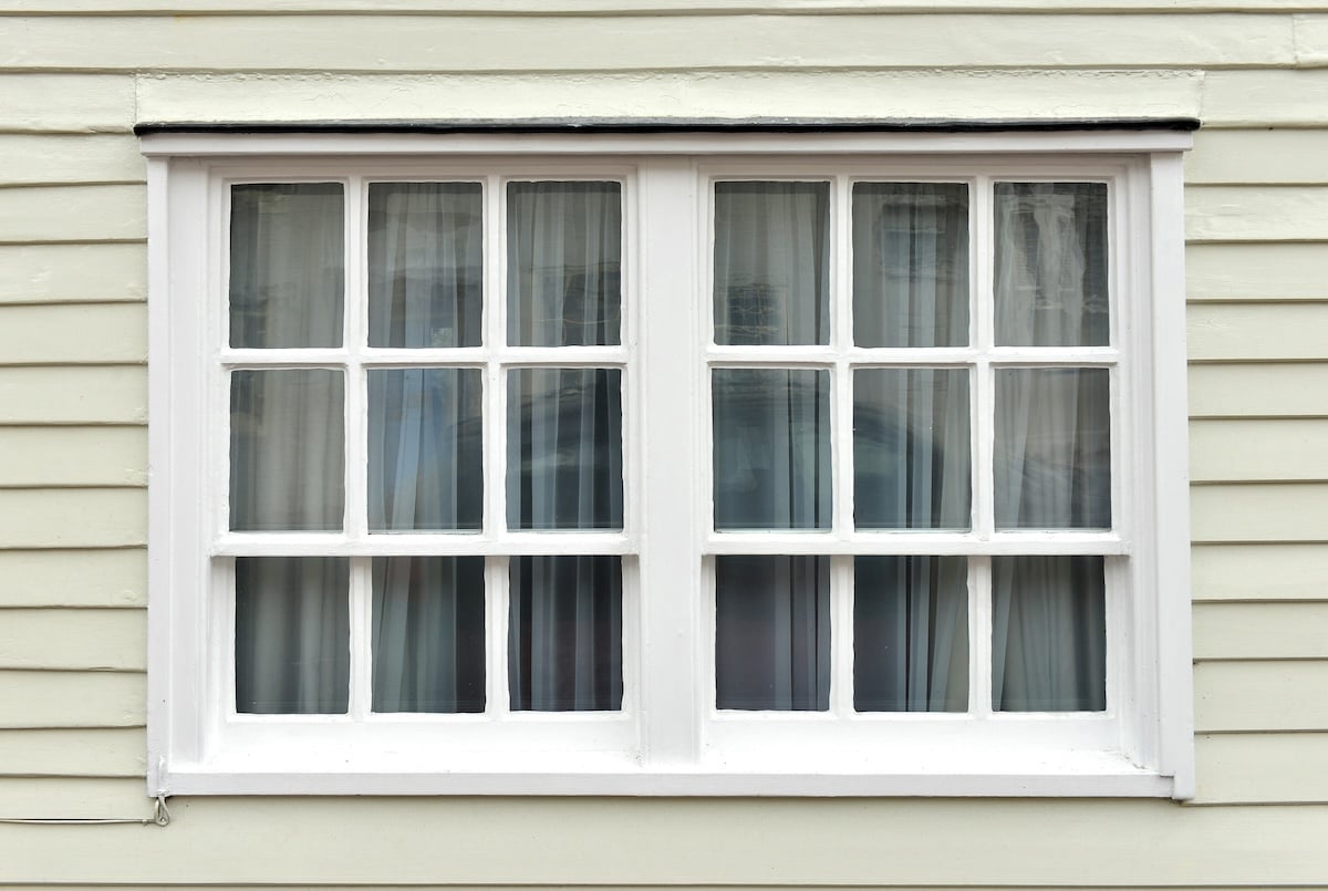 Old sash window and weatherboarding on house