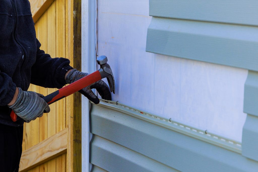 siding maintenance Replacing plastic siding on an exterior wall of residence house
