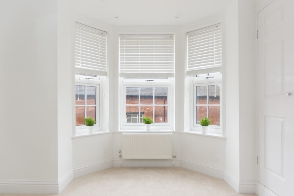bow windows An empty modern room in an urban apartment with plain white walls and bow window