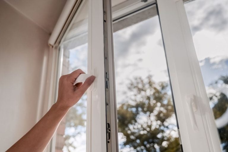 hand opening a double pane window