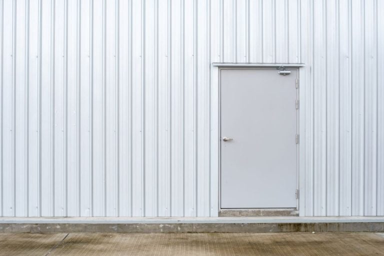 white metal wall with a metal door