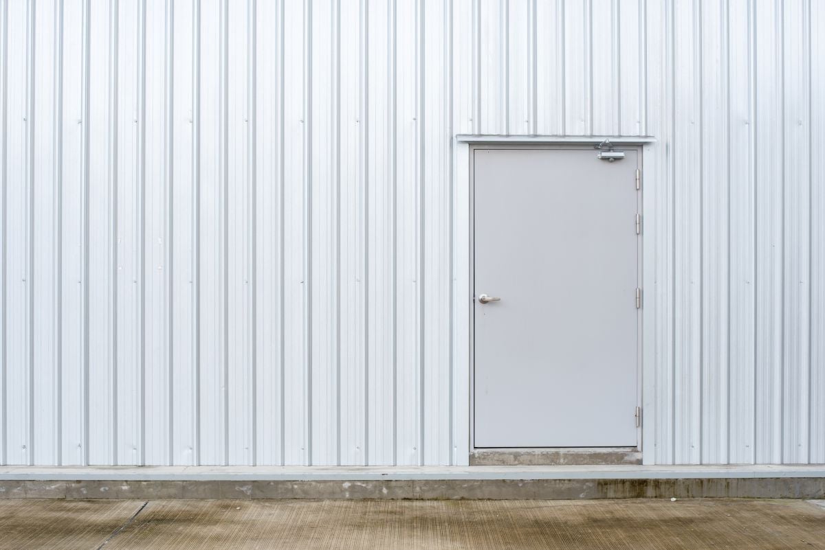 white metal wall with a metal door
