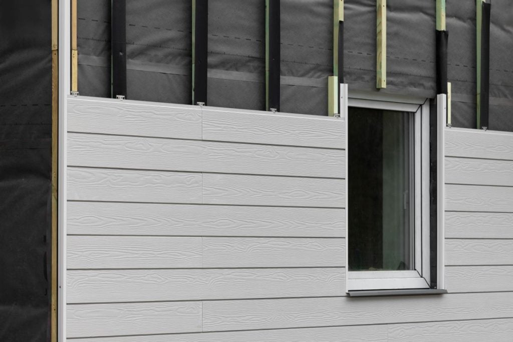 wood texture composite cladding installation on house facade