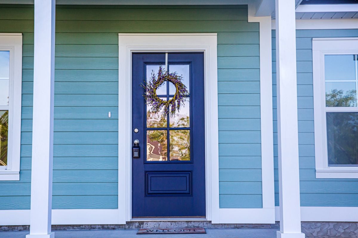 dark blue creaky door blue siding big old house