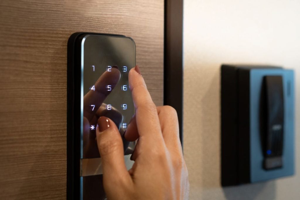 new wooden door security woman manipulating smart lock
