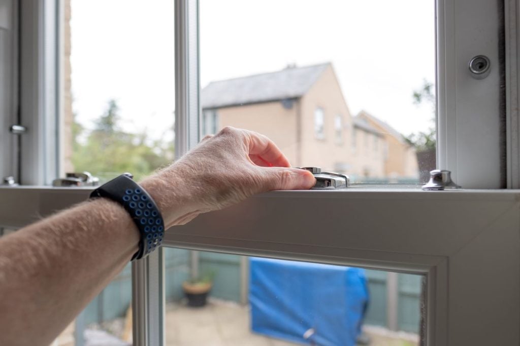 soundproof windows man's hand closing