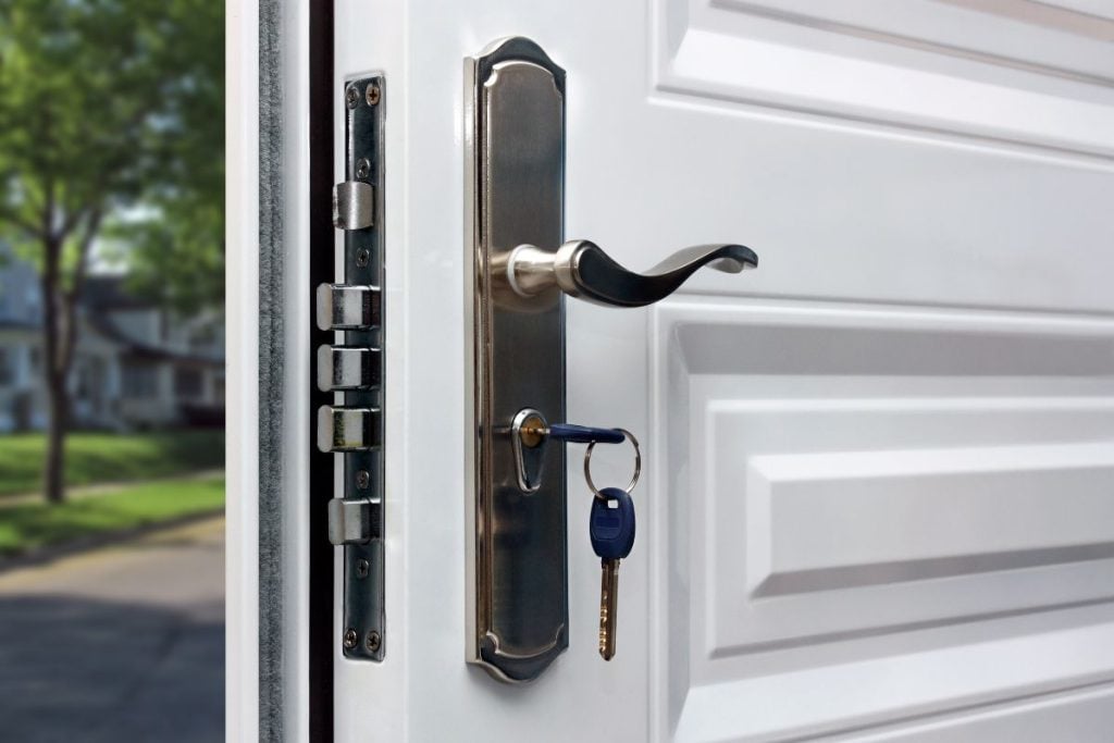 white door security close up metallic plate