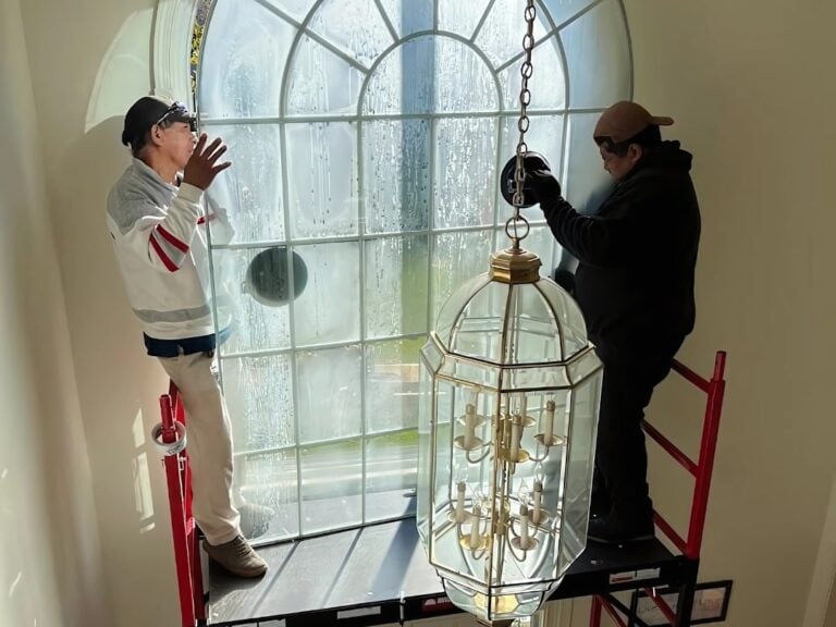 window replacement rockville workers replacing big window inside house
