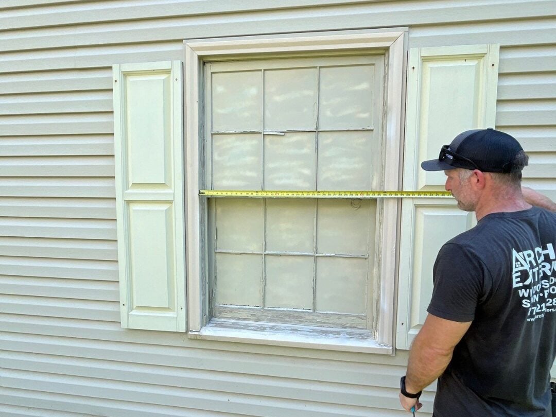 window replacement rockville worker measuring frame