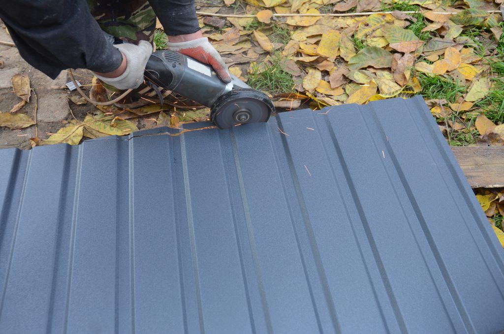 james hardie siding warranty A man is cutting a corrugated metal sheet, steel roof or siding panel with an angle grinder.
